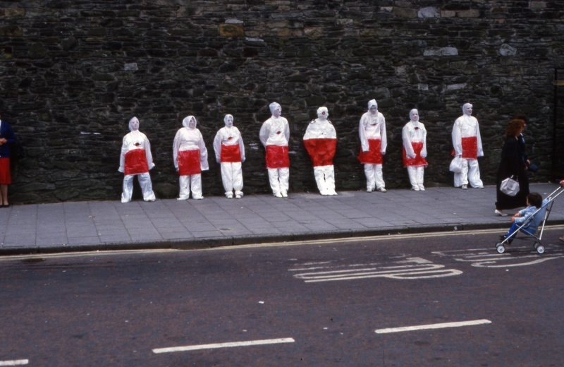 In Their Place (1986) &nbsp;City walls, Derry. Nine life size figures. Re-inforced concrete, paint, reflectors, metal rings. Guildhall Square bustop figure (street theatre performance)
