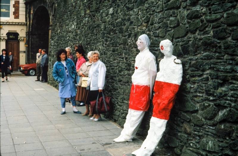 In Their Place (1986) &nbsp;City walls, Derry. Nine life size figures. Re-inforced concrete, paint, reflectors, metal rings. Guildhall Square bustop figure (street theatre performance)