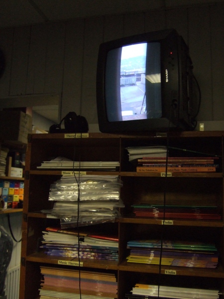 Of Note (2001) variable dimensions. Upturned TV, DVD (view Hendersons Music, Derry) &lsquo;&hellip;Morris&rsquo;s current studio is located within Derry&rsquo;s inner walled city, above a musical instruments shop. In 2001 he made &lsquo;Of Note&rsquo; a twelve minute looped video-work taken by a camera directed out from his studio rear door and overlooking the, by now classic, view of the Bogside area of he city. Given the heavy and sophisticated surveillance equipment stationed on the walls, it is clear that the artist has produced an ironic &lsquo;take' on the official viewing of the area. What is also evident is that there is nothing of note to record - a woman passes by, it rains, an external air conditioning unit kicks in to operation. The footage is banal and boring now that the drama of the Bogside has been apparently played out. Its banality is further reinforced by the accompanying monotonous sound track, inspired by the regular piano tuning sessions sounding up from the music shop below, which also contributed to the artwork&rsquo;s layered title &lsquo;Of Note&rsquo;. There is also&nbsp; a kind of comic resistance in the mimicry of the work, if not menace&hellip;&rsquo; (text extract Art and the Disembodied Eye, Liam Kelly, Golden Thread Gallery 2007)&nbsp; &nbsp;