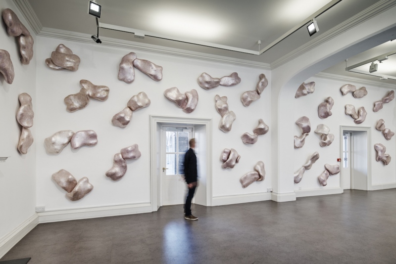 Comm (1992) variable dimensions. Toilet paper Papier mache, cling film, ink, sealed with flame. Collection Irish Museum of Modern Art